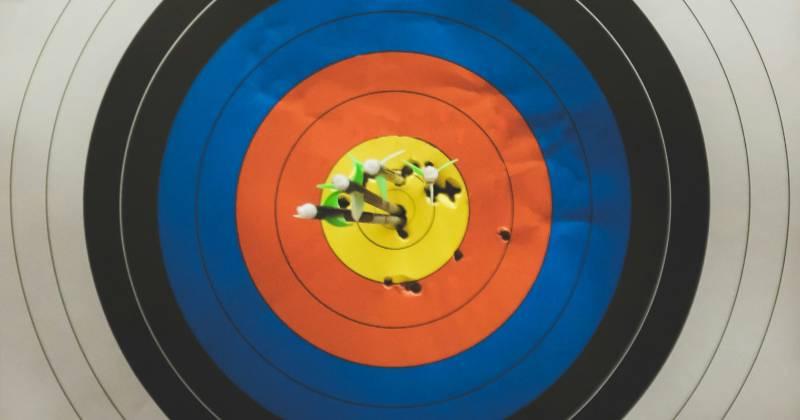 A target with arrows grouped in the center